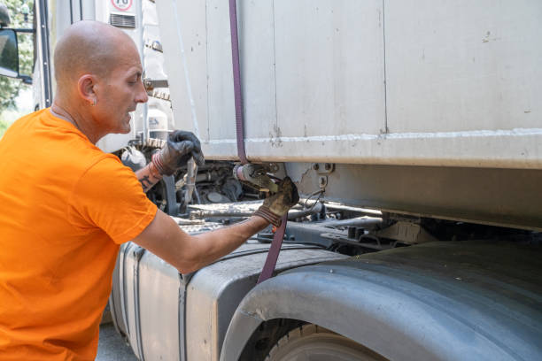 A big truck driver with his truck.