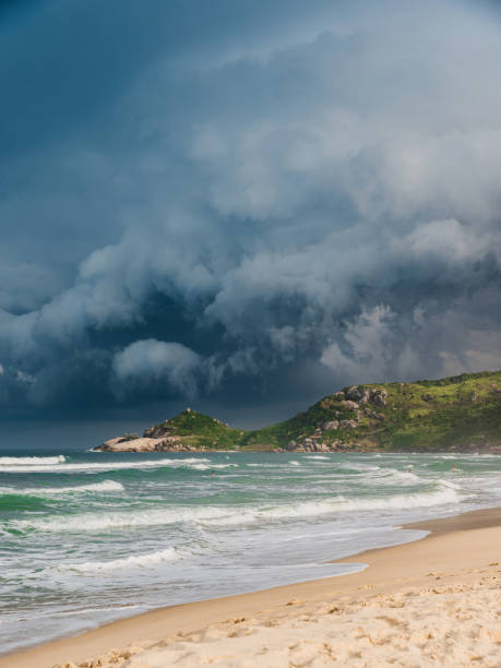 istock Scenic beach with sunlight before an oncoming storm. Mole beach in Florianopolis 1542588300