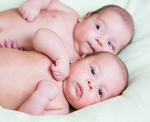 istock funny newborn baby twins lying one next other 154259079