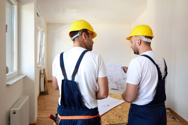 istock Rear view of workers examining housing project during home renovation process. 1542607362