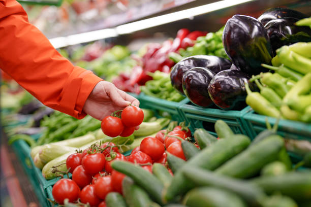 istock Man shopping vegetables in groceries store 1542614865