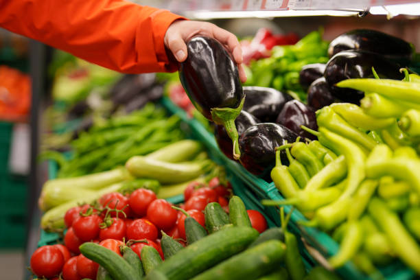 istock Man shopping vegetables in groceries store 1542614869