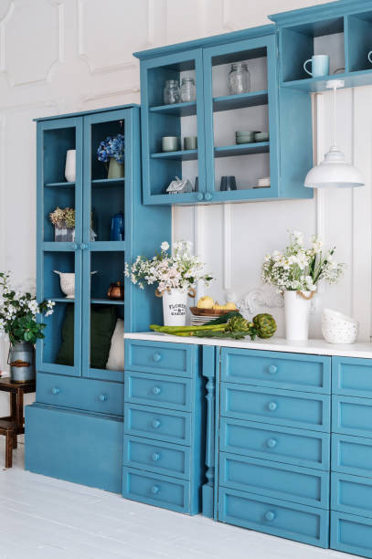 istock Vertical shot of monochrome kitchen counter with blue drawers 1542620183