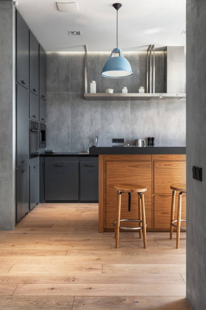 istock Elegant kitchen with gray cabinet, wooden table and chairs 1542620185