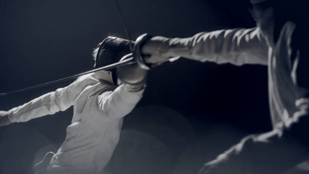 istock Two professional fencers clashing in combat. Pushing forward in offensive and parrying 1542652026