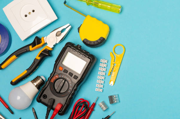 istock Electrician equipment on blue background with copy space.Top view.Electrician tool set.Multimeter, tester,screwdrivers,cutters,duct tape,lamps,tape measure and wires.Flet lay. 1542653633