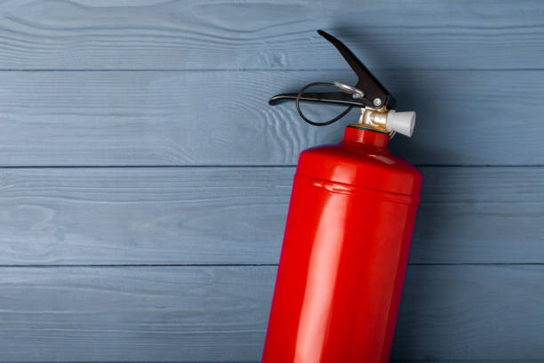 istock Fire extinguisher on a  background. Fire protection, home fire extinguisher. home security concept. Place for text. Copy space.banner 1542656350