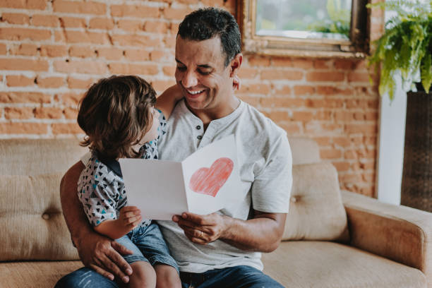 istock Son handing postcard to father on father's day 1542664842