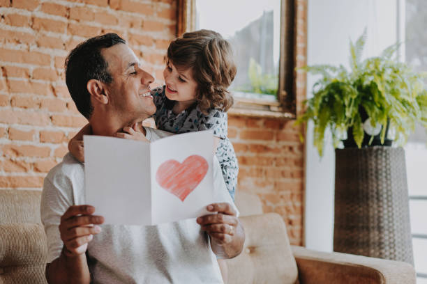 istock Son handing postcard to father on father's day 1542664989