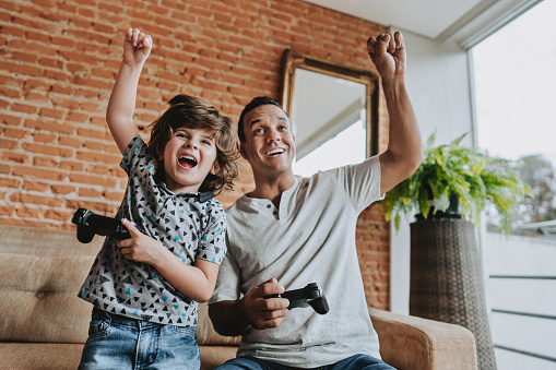 Father and son playing video games together