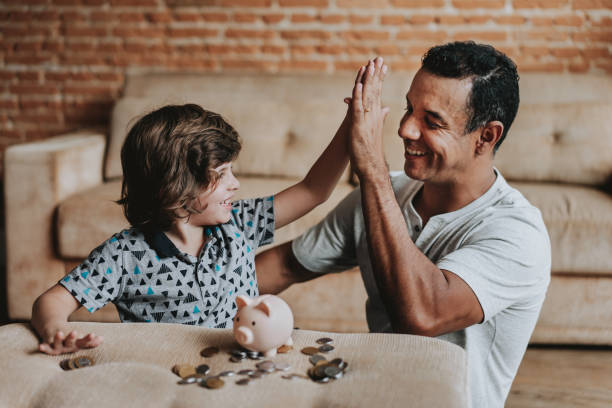 istock Father and son coin bank 1542666600