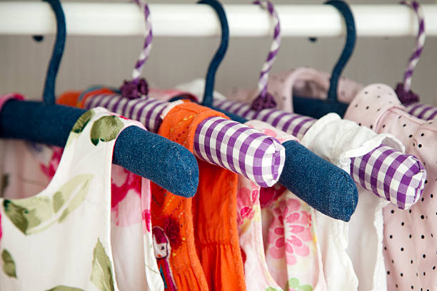 Colorful dresses hanging in wardrobe stock photo