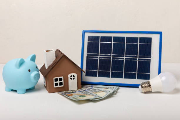istock Flat lay composition with solar panel, led lamp and piggy bank on  background. The concept of saving money and clean energy. The concept of ecology and sustainable development. 1542677869