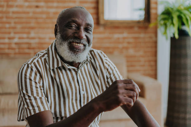 istock Portrait of senior man looking at camera at home 1542678430