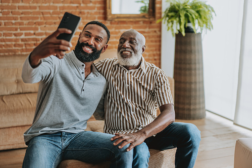 Senior father and eldest son using smartphone