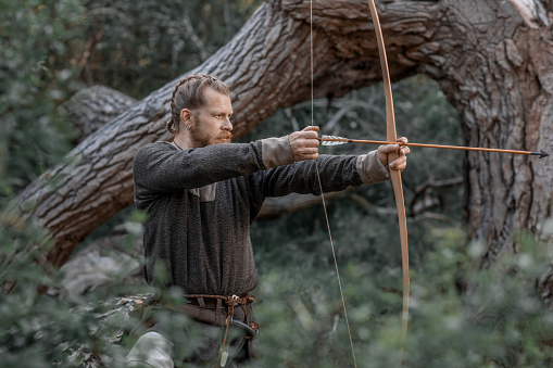 An individual viking archer warrior in the north European forest countryside