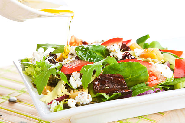 istock Pouring olive oil on fresh salad. 154268748