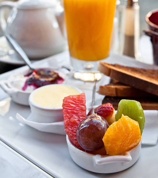 istock Breakfast with orange juice and fresh fruits on table 154268914