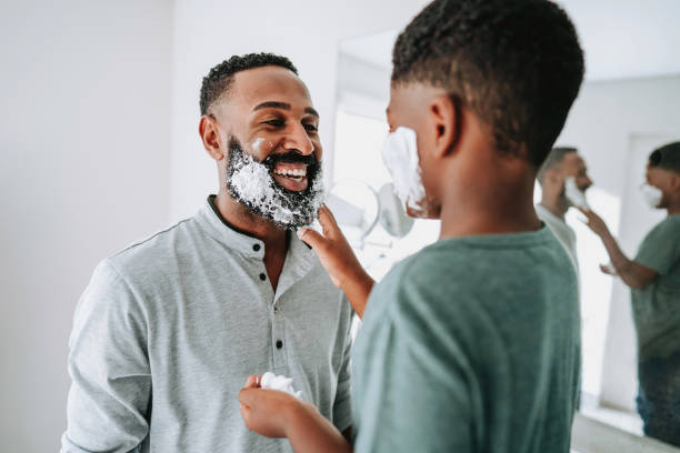 Father and son having fun shaving father's day
