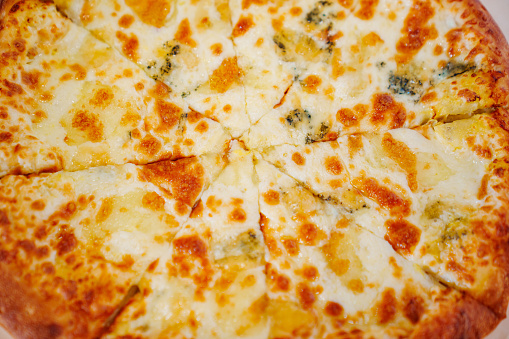 Appetizing cheese pizza. A traditional delicious dish of Italian cuisine.