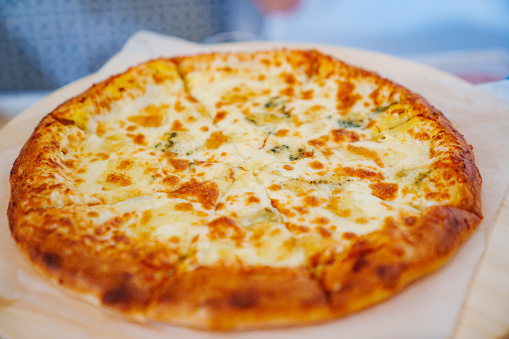 Appetizing cheese pizza. A traditional delicious dish of Italian cuisine.