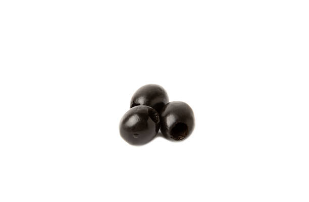 istock Tasty black olives isolated on white background. Olive and olive tree branches on a white table. Delicacy. 1542695903