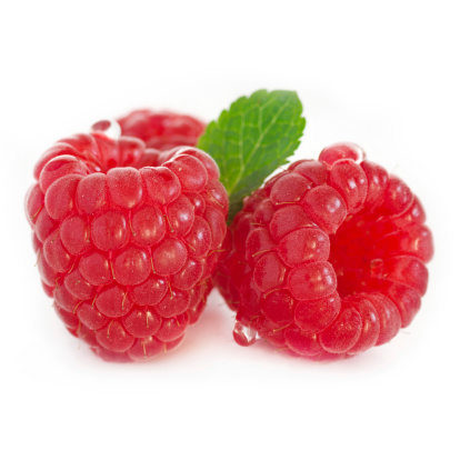 Three raspberries with water droplets