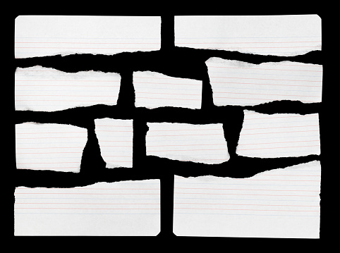 White ripped pieces of lined paper on black with blank space for text. Thif file is cleaned and retouched.