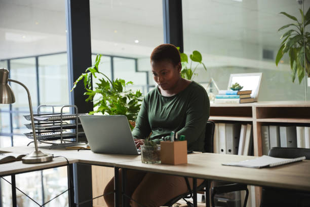 istock Creative workspace, business and black woman on computer working on online project, report and planning. Eco friendly office, productivity and female worker on laptop for website, internet and email 1542713838