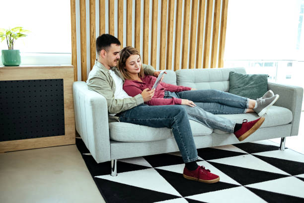 istock Smiling young couple using digital tablet at home 1542726517