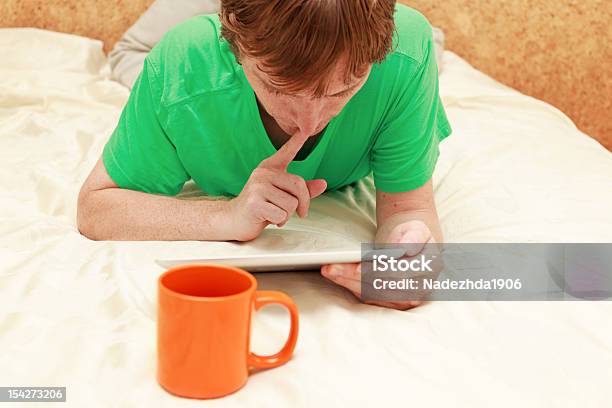 Man With Touch Pad At Home Stock Photo - Download Image Now - Adult, Adults Only, Bedroom