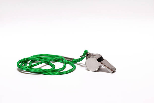 Pea whistle with a green string on white background stock photo