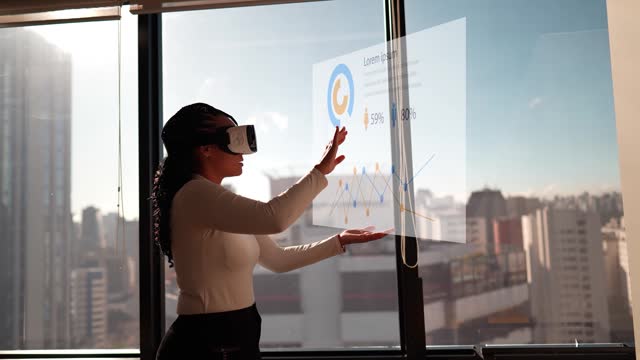 Young woman working using virtual reality simulator at office
