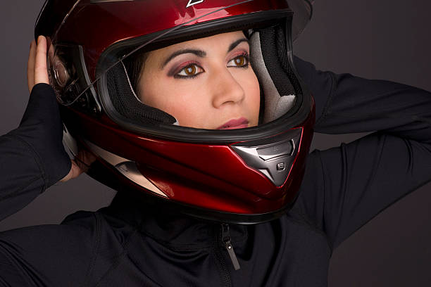 istock Female Rider Dressed in Black Adjusting Full Face Motorcycle Helmet 154277239