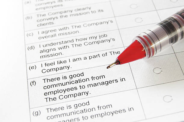 istock Someone taking a opinion survey with a red pen 154277385