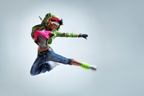modern style dancer jumping on studio background