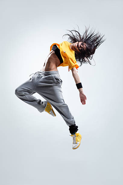 modern style dancer jumping on studio background