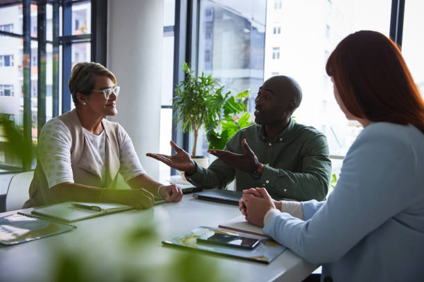 istock Business people, meeting and group in discussion, collaboration with workshop ideas for project. Employees working together, black man and women with communication, agenda and teamwork at startup 1542785308