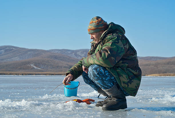 istock Man on winter fishing 154279631