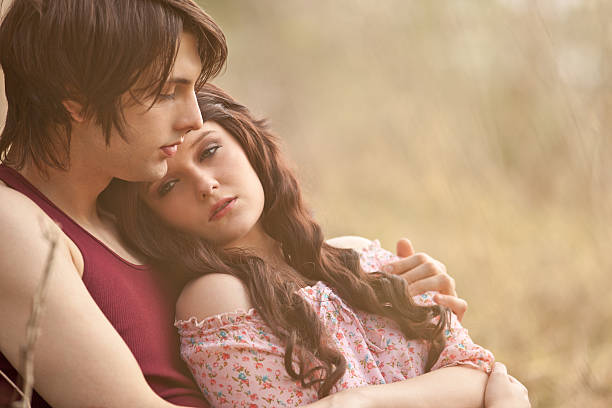 Young man holding his girlfriend in his arms