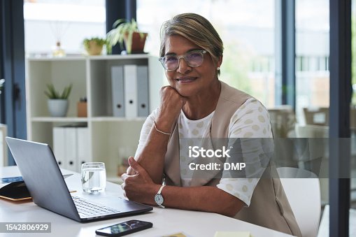 istock Laptop, smile and portrait of old woman at desk, secretary  in professional office management and online schedule. Internet, computer and happy senior receptionist working for administration business 1542806929