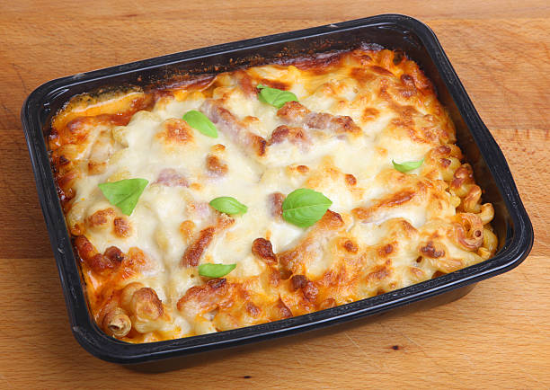 Baked Pasta Ready Meal Baked pasta ready meal with spiral pasta, chicken, bacon and cheese. convenience food photos stock pictures, royalty-free photos & images