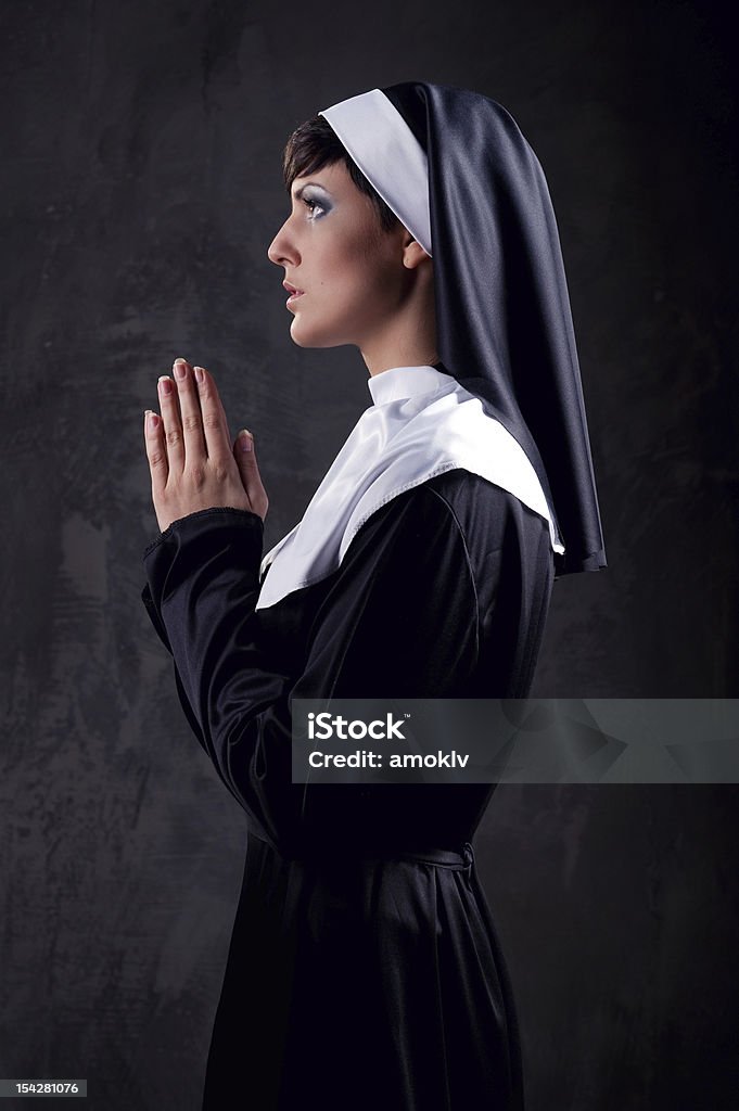 Now praying Young attractive nun praying Adult Stock Photo