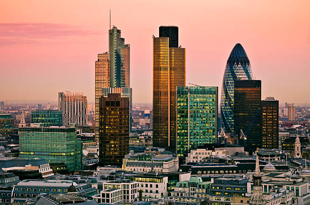 Buildings in the city of London under a pink sky at twilight City of London one of the leading centres of global finance.this view includes Tower 42 Gherkin,Willis Building, Stock Exchange Tower and Lloyd`s of London gherkin london night stock pictures, royalty-free photos & images