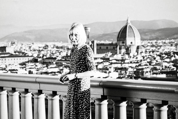 Angry tourist at a famous viewpoint overlooking the city of Florence in Tuscany, Italy. Monochrome with grain.
