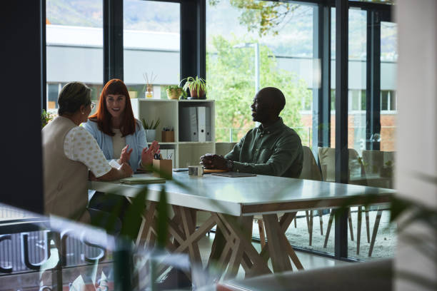 istock Meeting, discussion and team in planning in the office boardroom for a creative project. Conversation, brainstorming and group of designers working in collaboration in the workplace conference room. 1542834612