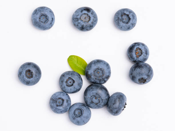 istock Fresh blueberries with blueberry leaves isolated on white background. View from above. Fresh raw berries 1542847468