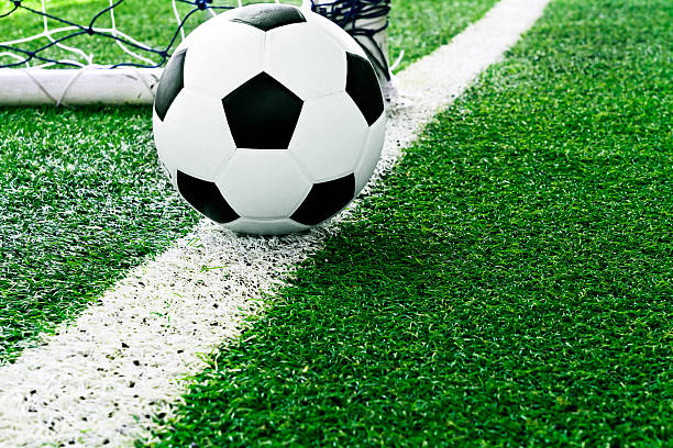 istock Soccer ball on green grass 154284781