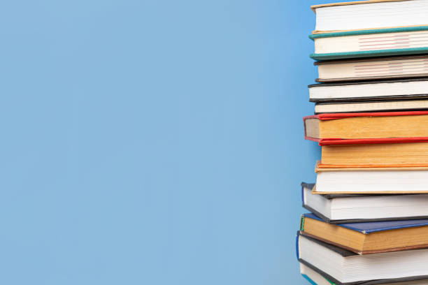 istock Composition with vintage old hardback books, diary on blue background. Books stacking. Back to school. Copy Space. Education background. 1542854455