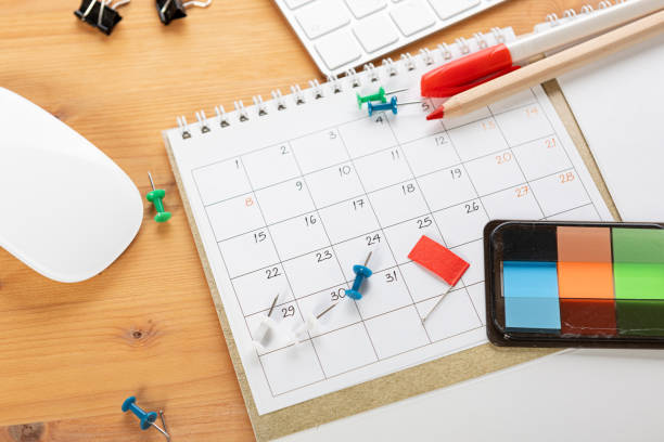 istock Planner plan Schedule Calendar and agenda reminders, work from home online. desktop calendar with stationery and pen pencil, keyboard for plan daily meeting and note holiday trip in diary at office desk. 2023 calendar reminder concept. 1542875346